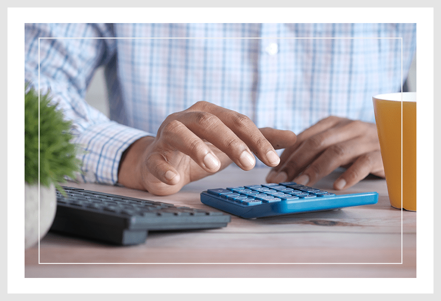 A person using their calculator on the table